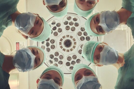Photo by National Cancer Institute surgeons looking down under operating light